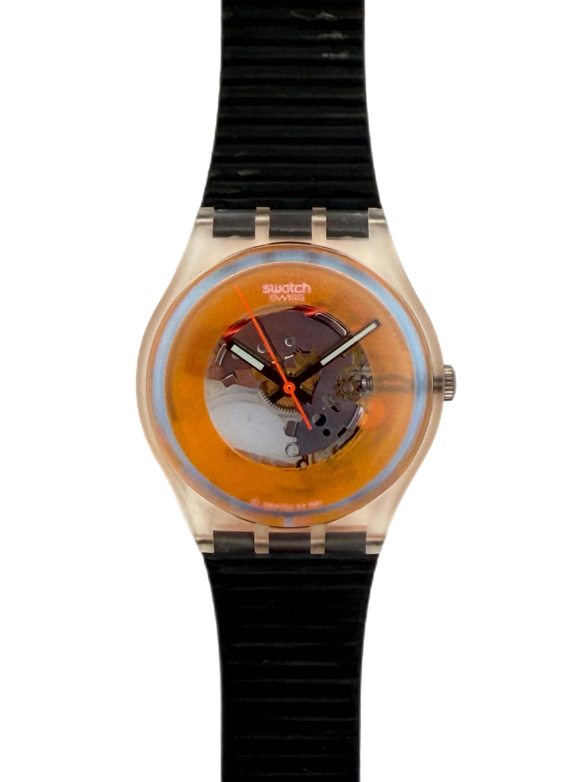 Swatch Swatch One wristwatch with a translucent orange dial, visible mechanical movement, and a black ribbed silicone strap on a white background.