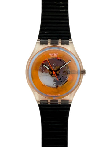 Swatch Swatch One wristwatch with a translucent orange dial, visible mechanical movement, and a black ribbed silicone strap on a white background.