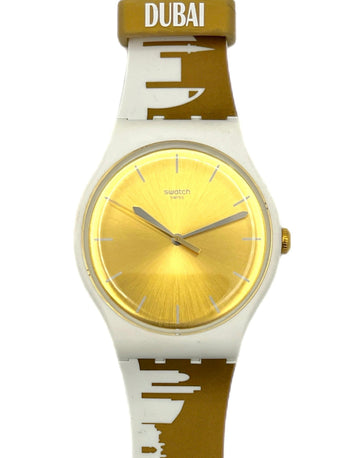 Watch with gold face and white and brown strap on a white background