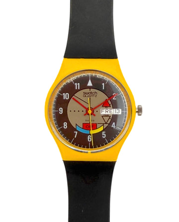 Swatch wristwatch with a bright yellow case, black strap, and a brown dial featuring colorful Swatch logo graphics and a day/date window.