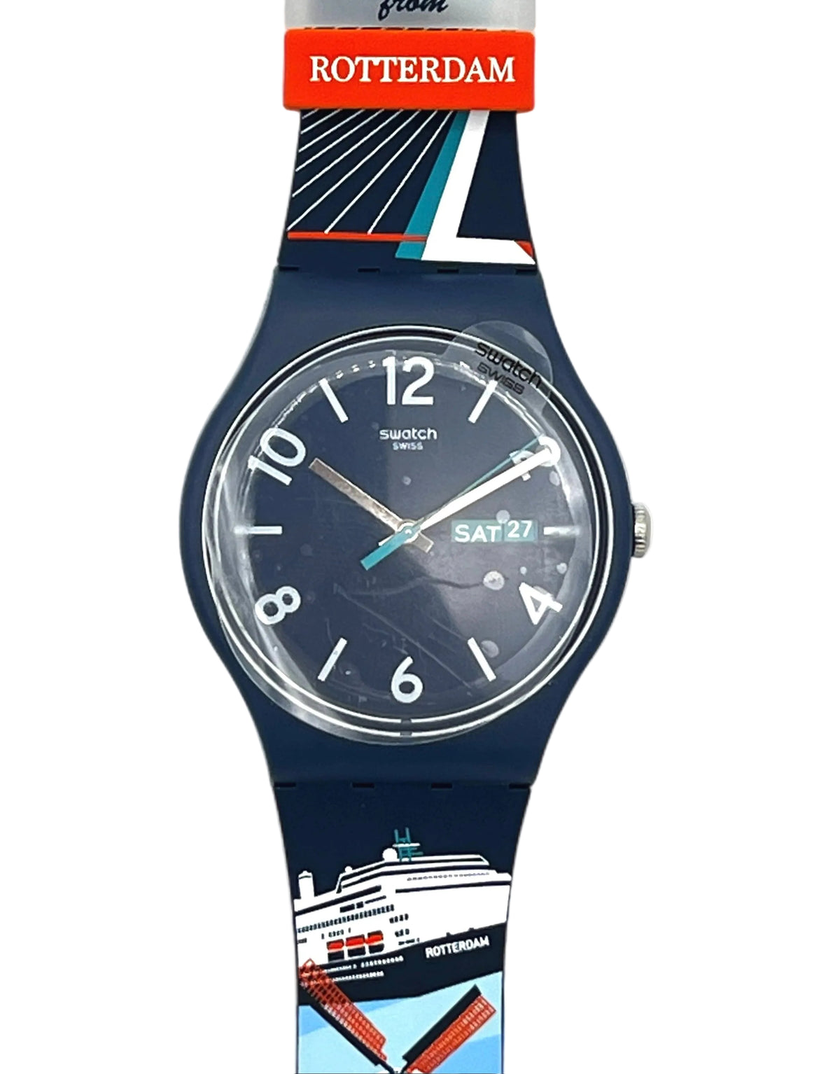 A Swatch wristwatch with a dark blue silicone strap featuring a Rotterdam travel-themed print, including a cruise ship and windmills, with a red and white 'Greetings from ROTTERDAM' paper tag attached at the top.