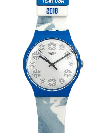 Swatch Swatch Team USA 2018 wristwatch with a blue case, white dial with snowflake patterns, and a blue and white camouflage strap.