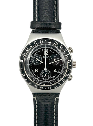 Swatch watch with black face and leather strap on a white background
