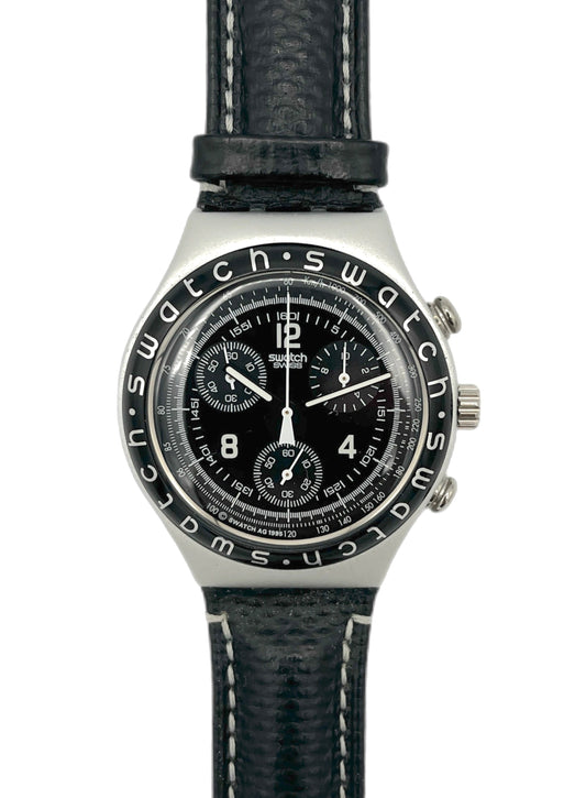 Swatch watch with black face and leather strap on a white background