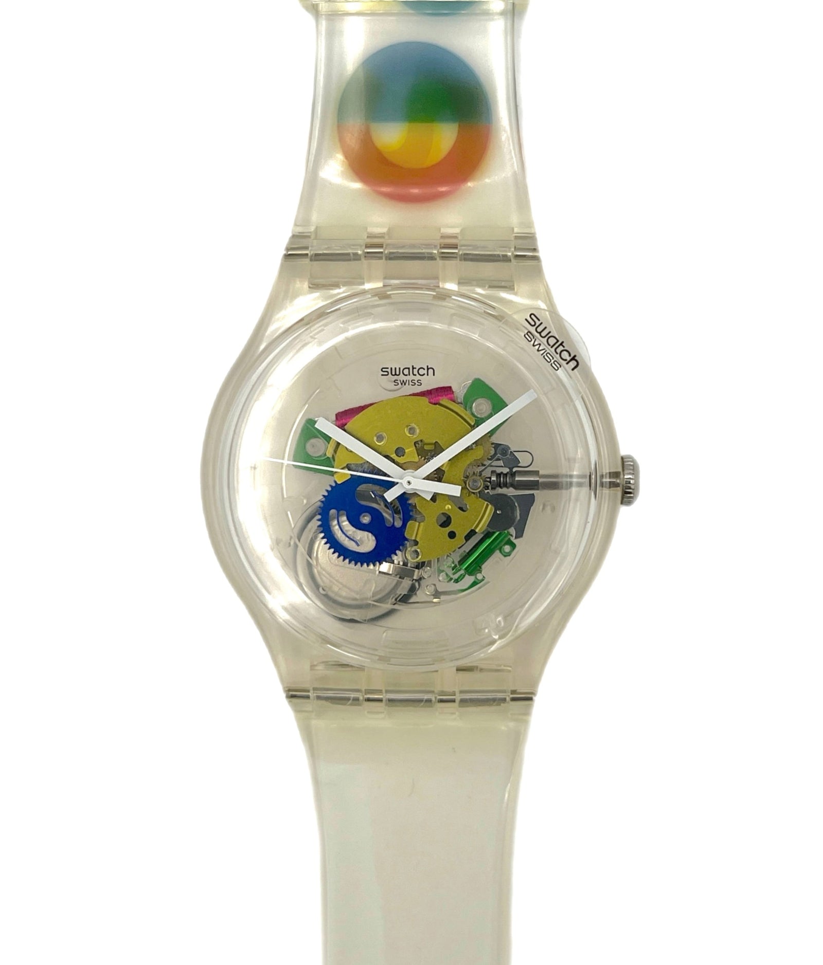 Clear Swatch watch with colorful face and Milano 2015 design on a white background