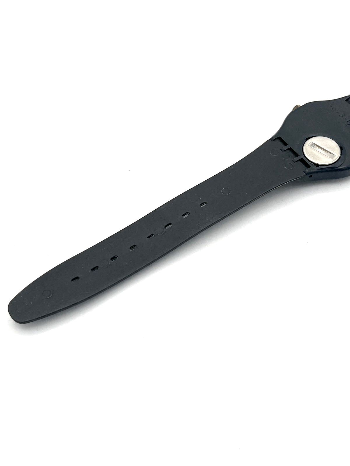 A close-up of a black watch strap with a silver screw closure on a clean white background.