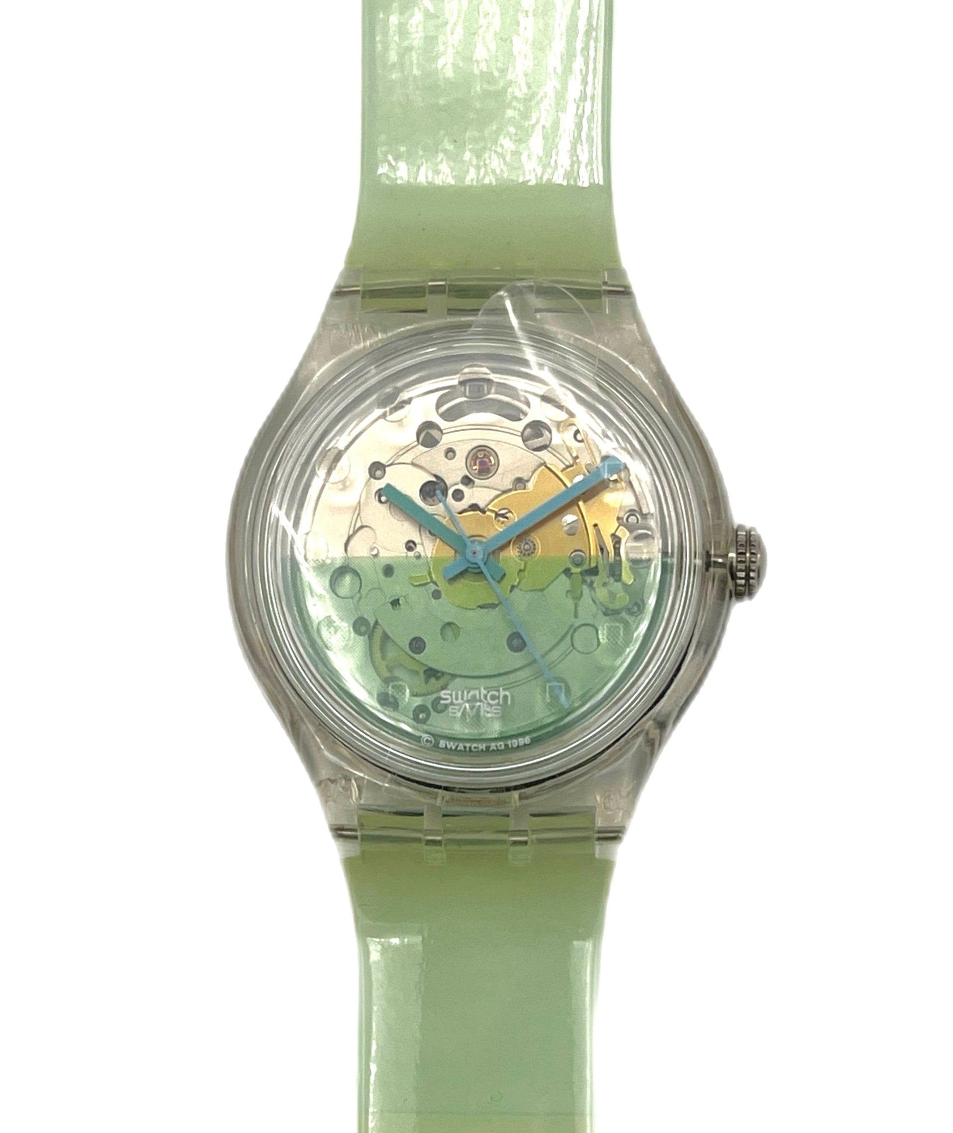 Green wristwatch with transparent case on a white background