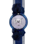 Wristwatch with blue floral straps on a white background