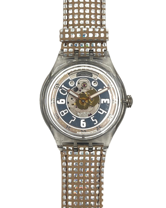 A vintage-style wristwatch with a rhinestone-embellished metallic strap and a skeleton dial showing a blue and gold inner mechanism. The brand name 'SWISS' is visible on the dial.