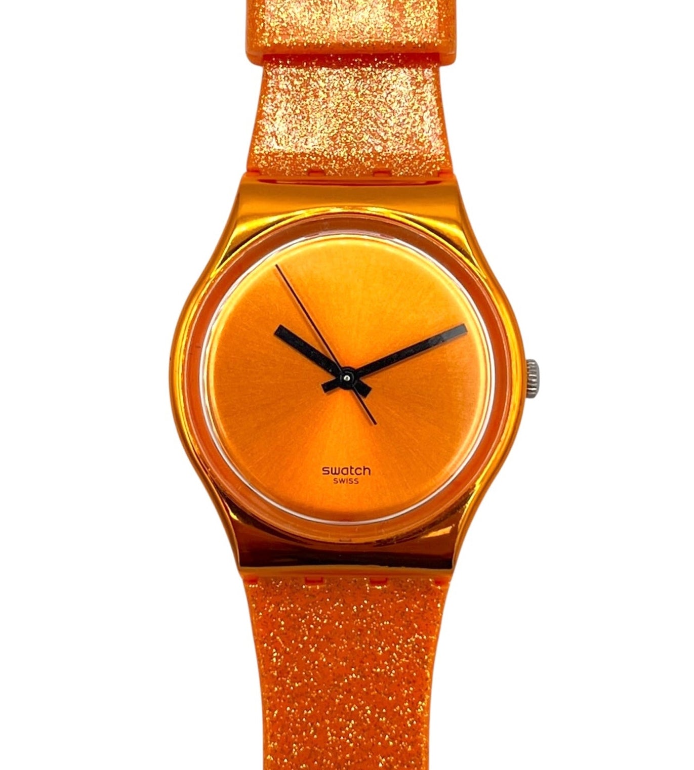 A Swatch wristwatch featuring a vibrant orange glitter strap and a matching orange dial with black hands, shown against a plain white background.