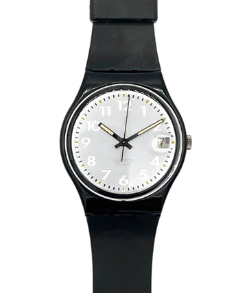 A Swatch wristwatch with a black round case, black strap, and a white dial featuring black Arabic numerals and gold-tone hands.