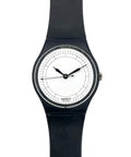 A Swatch wristwatch with a black silicone strap, black case, and a minimalist white dial with black hands.