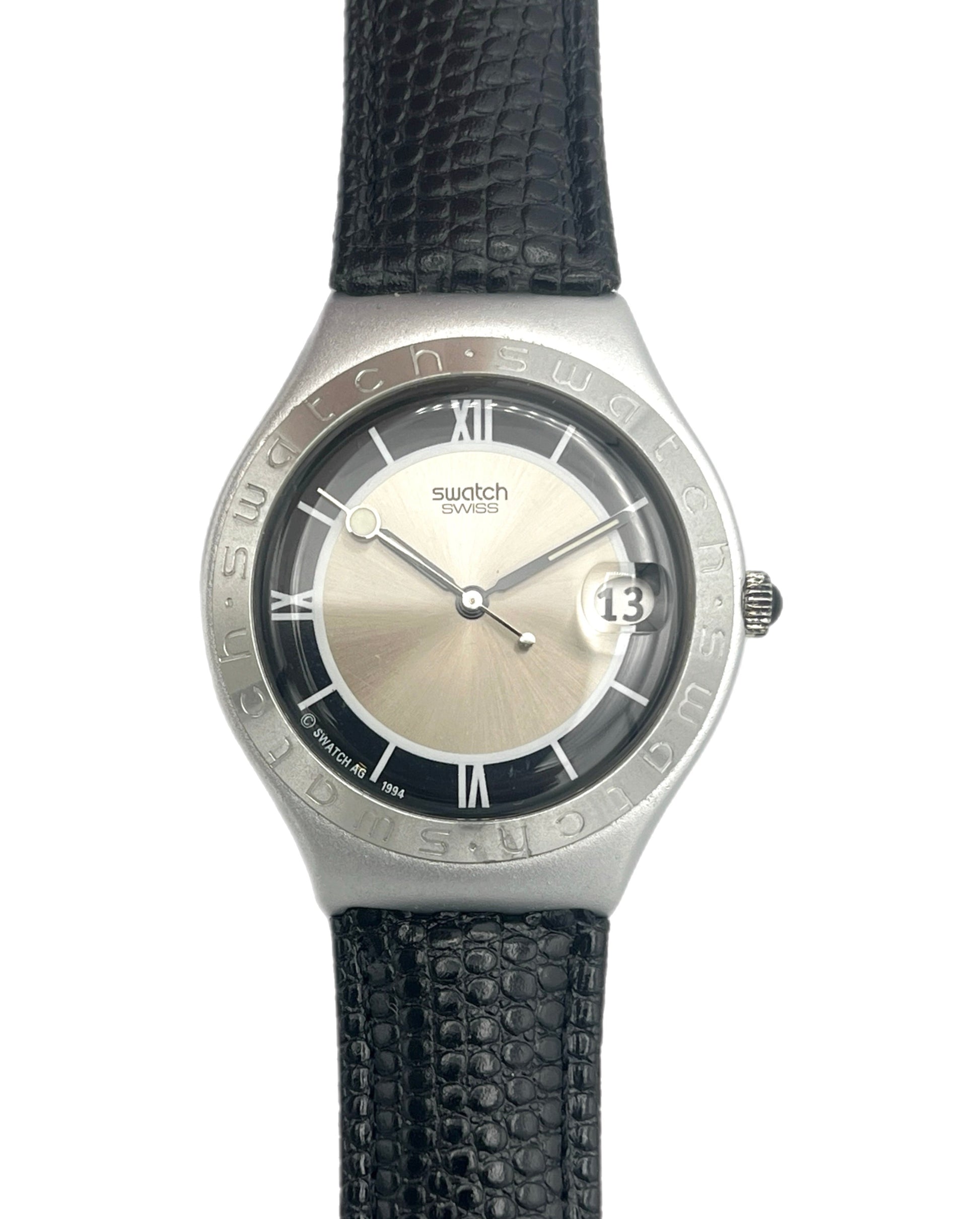 Swatch watch with black strap and silver case on a white background