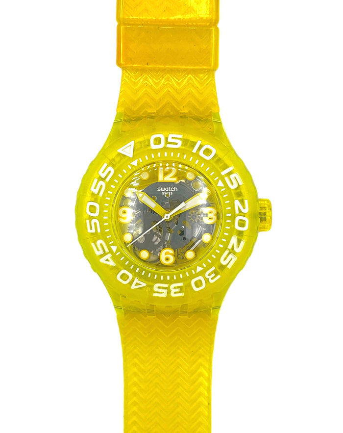 A Swatch wristwatch featuring a bright yellow translucent silicone strap and bezel, with a dark gray dial and white Arabic numerals.