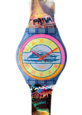 A Swatch wristwatch with a translucent blue case and a highly colorful, abstract-patterned strap. The dial features a yellow center with orange Roman numerals, red hands, and a blue boat illustration.