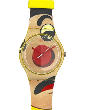 Swatch watch with a gold-tone case, a red and beige dial, and a matching patterned strap featuring a stylized face design in beige, black, red, and yellow.