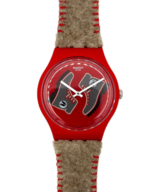 Red watch with a textured brown strap on a white background