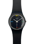 A Swatch wristwatch with a black silicone strap and a black round dial. The dial features white hands, a yellow 'DON'T' at the 12 o'clock position, and blue and green text at the 9 and 3 o'clock positions, with a small red 'LATE!' at the 6 o'clock position.
