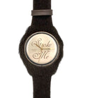 Wristwatch with black strap and gold face on a white background