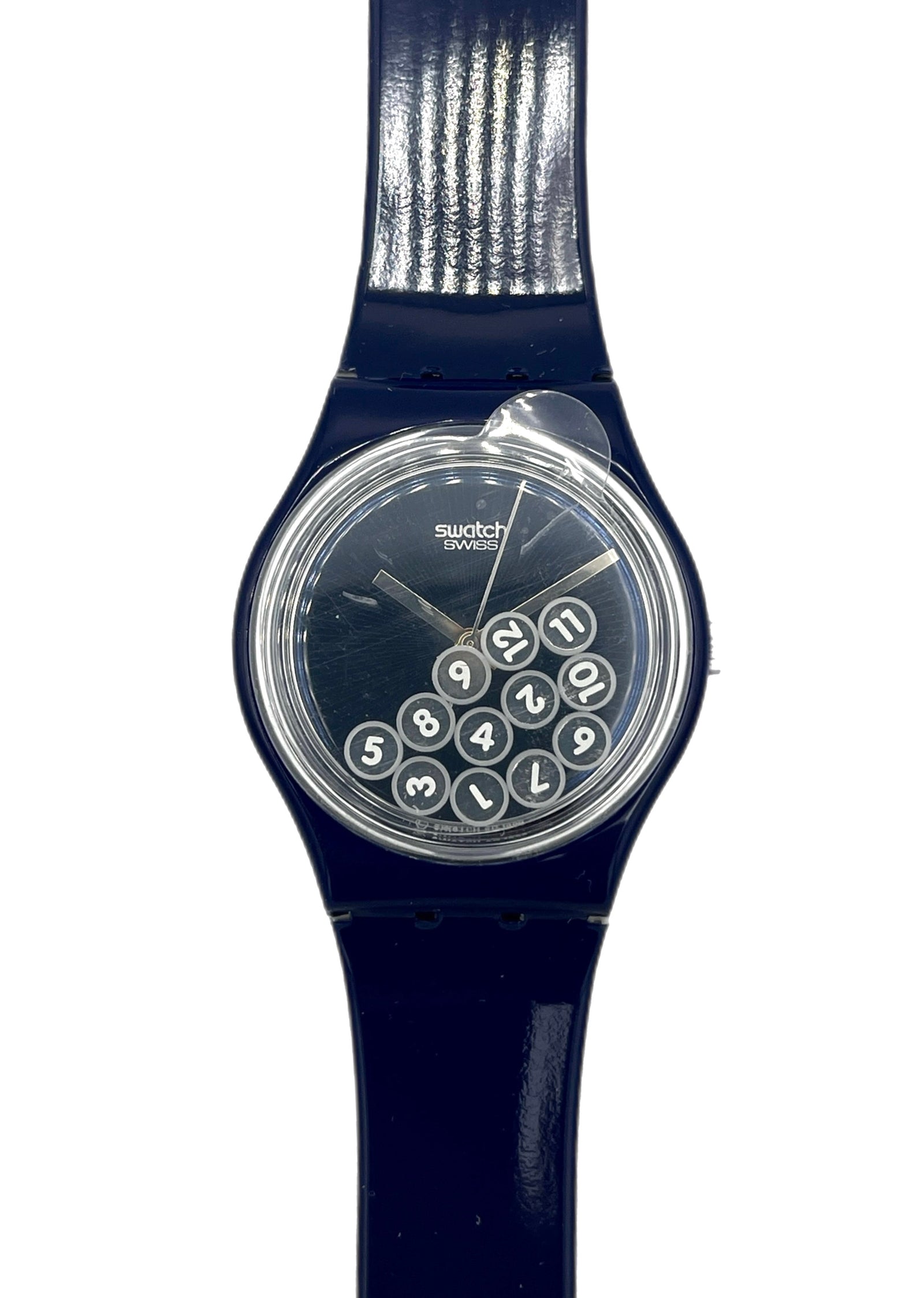 Navy blue Swatch watch with a clear face showing numbers on a white background